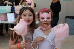 Children eating cotton candy at Purim celebration. 